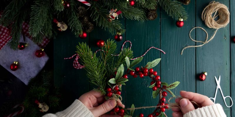 close-up-female-hands-decorate-a-christmas-wreath-2022-10-27-03-30-58